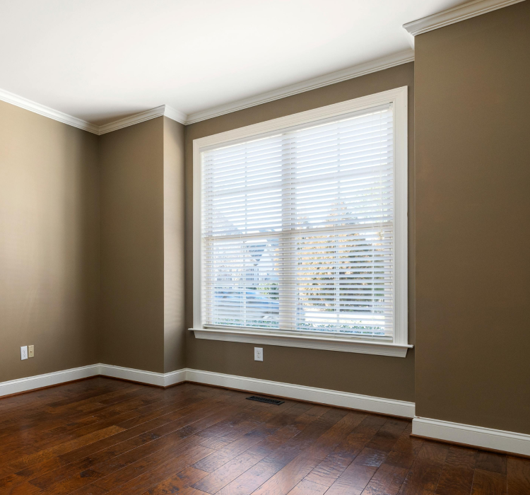 brown painted wall with dark stain wood flooring