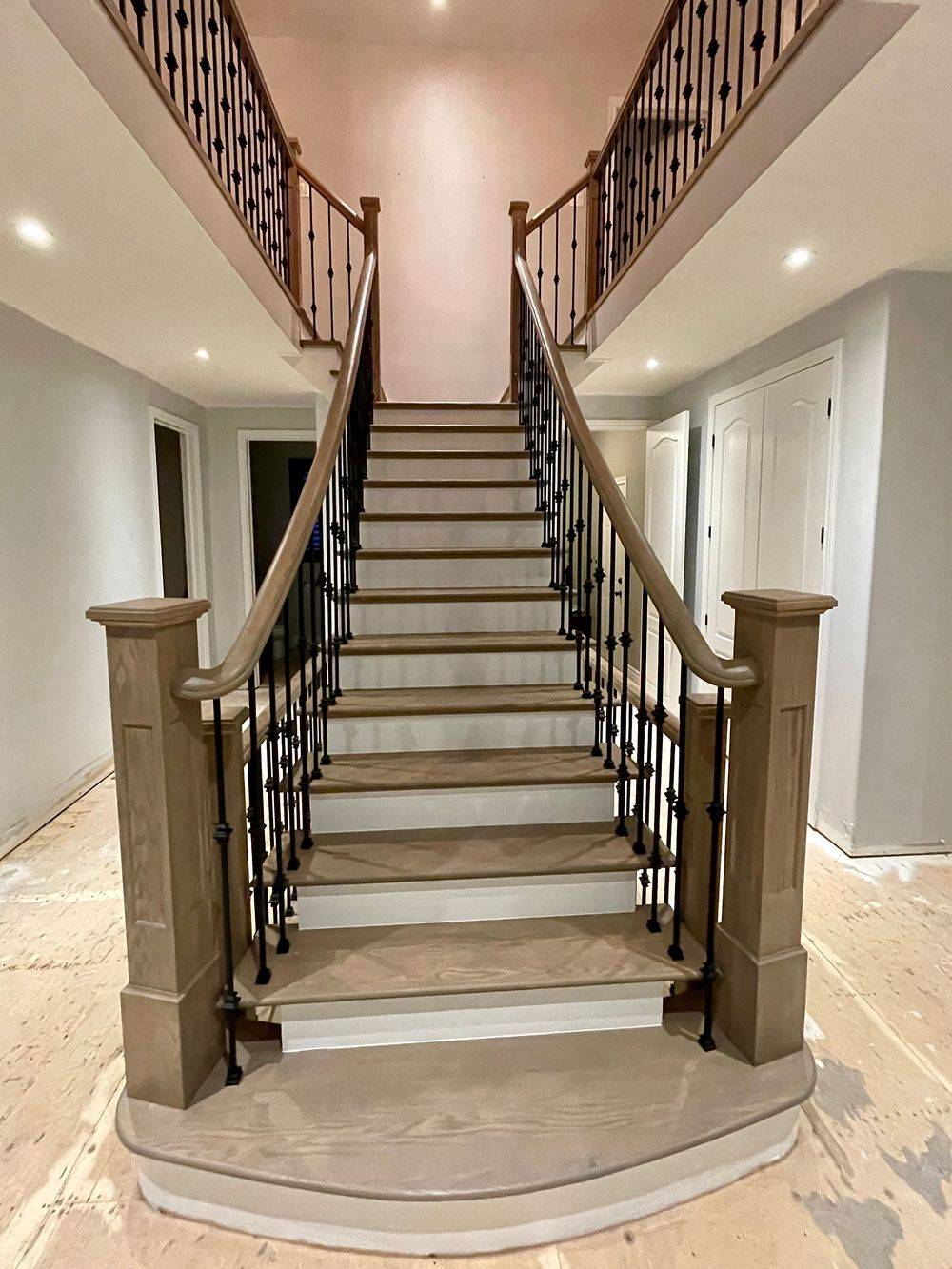 grand entryway staircase in light brown grey