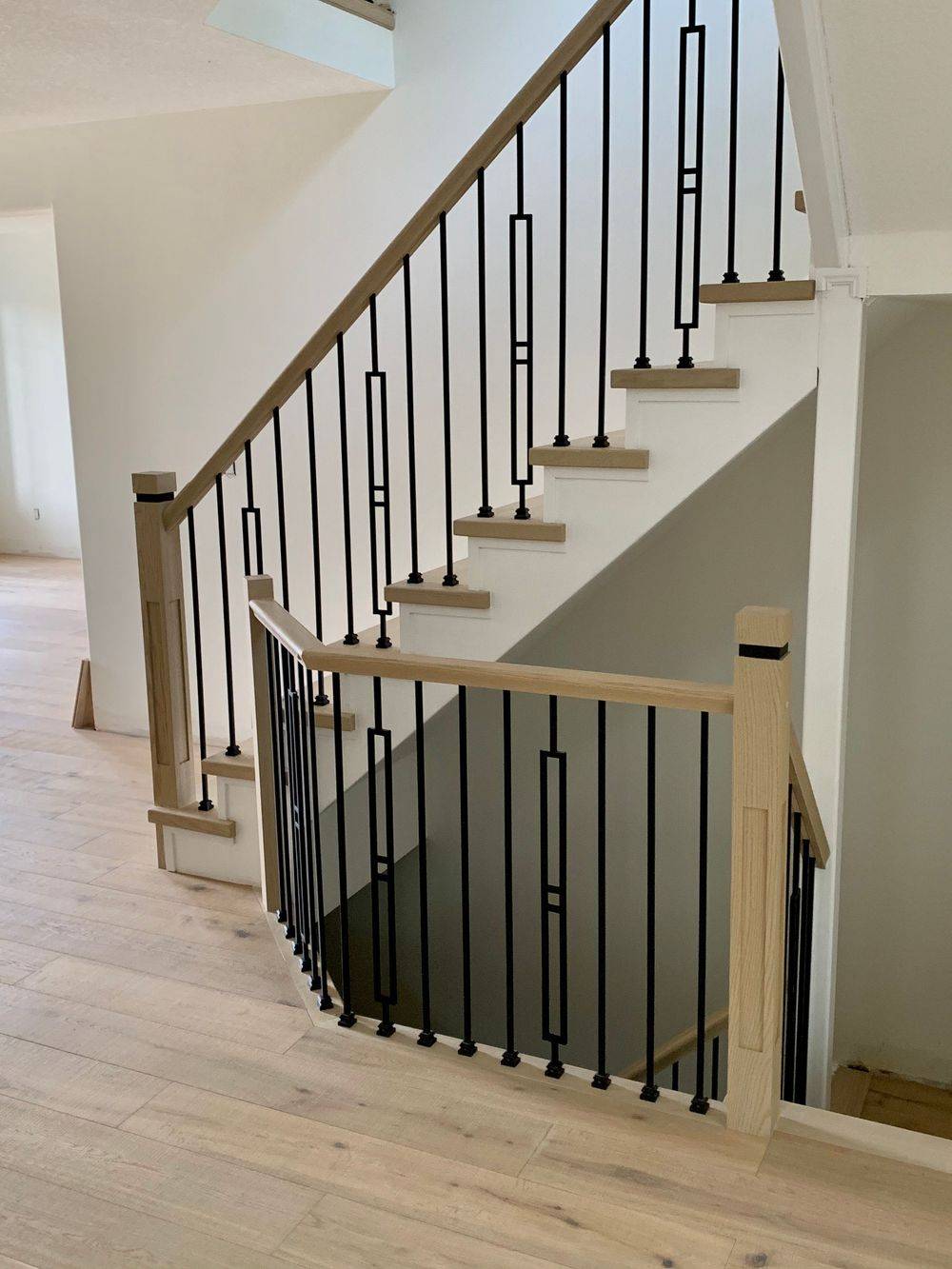 wrought iron spindles on light wooden staircase