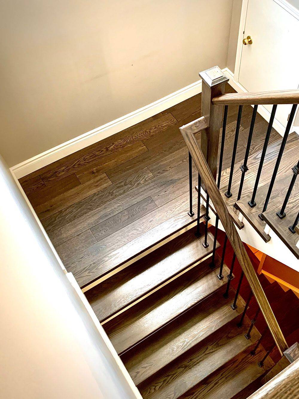 dark colored wood staircase and flooring