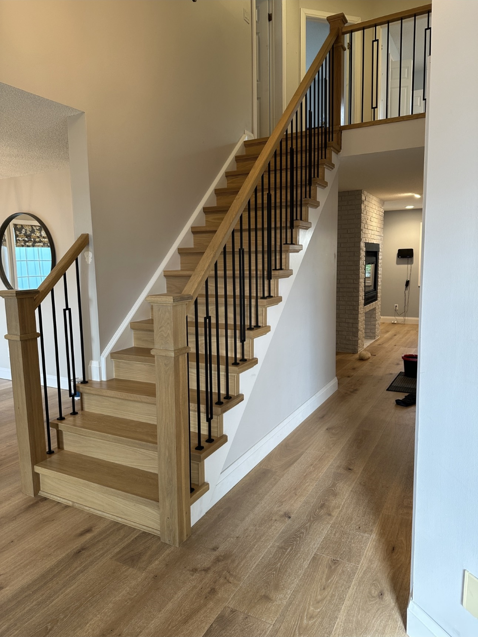 light wooden staircase with wrought iron spindles