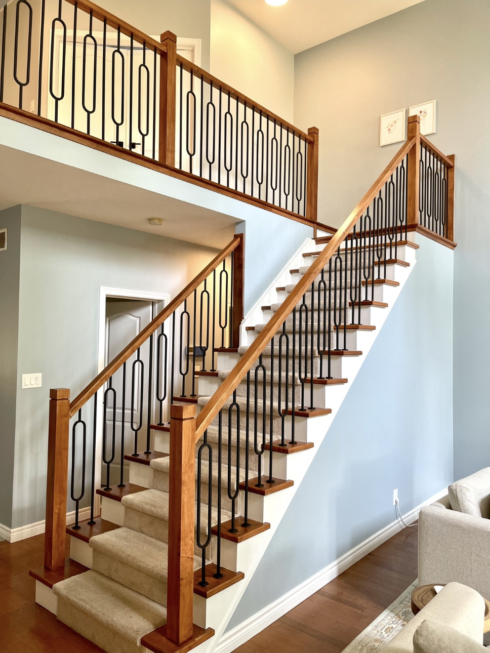 light wooden staircase with carpeting and blue painted wall