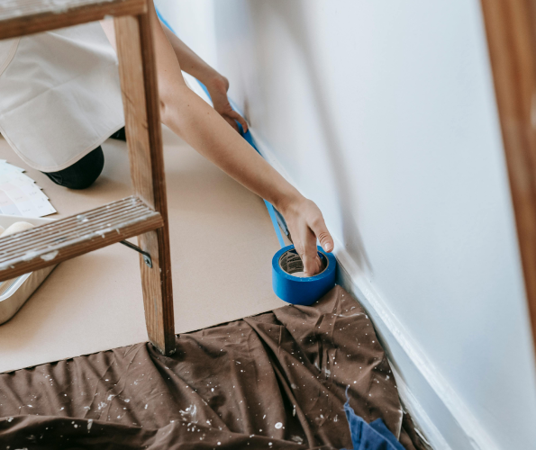 person painting baseboards